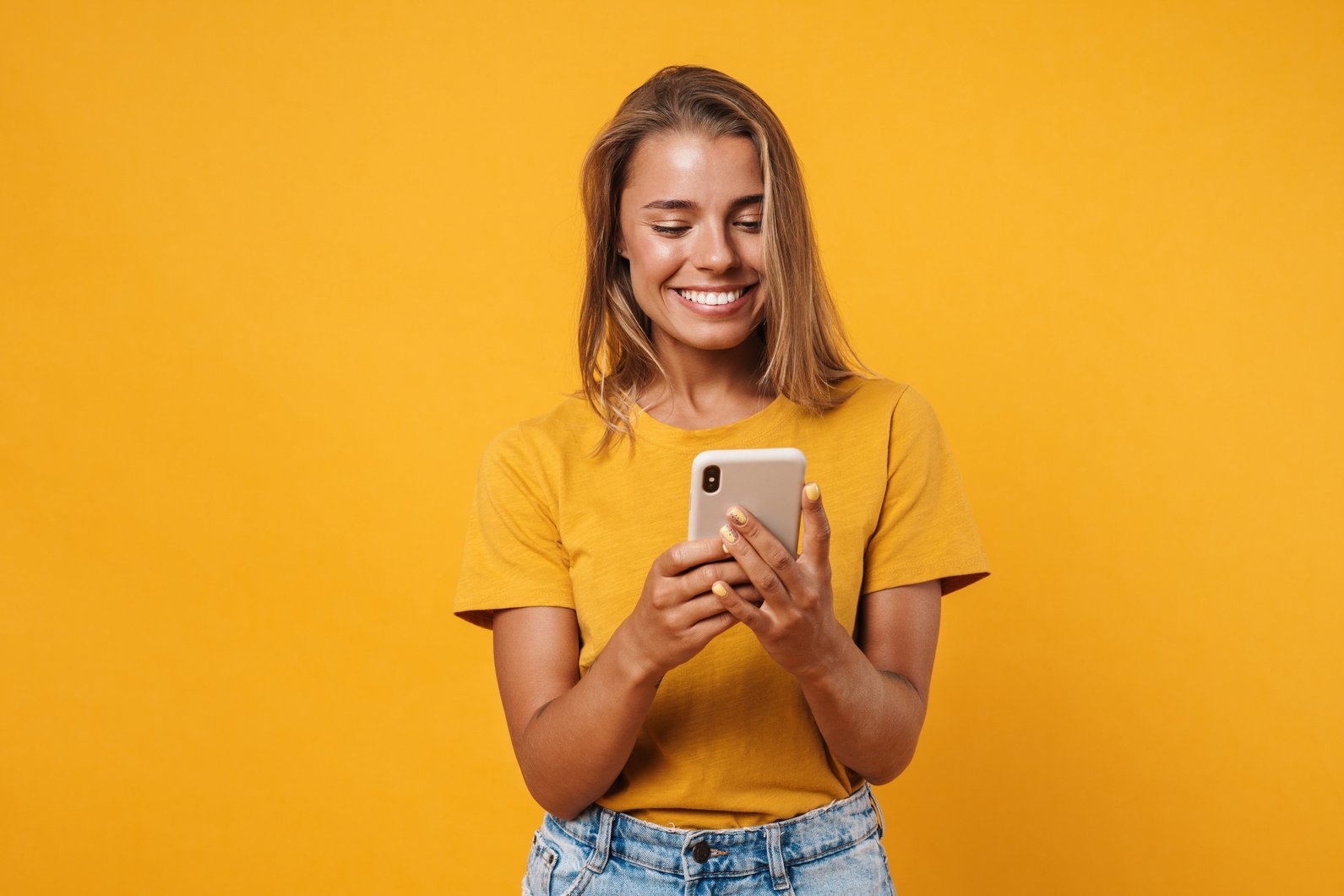 Portrait of a Smiling Casual Woman Holding Smartphone